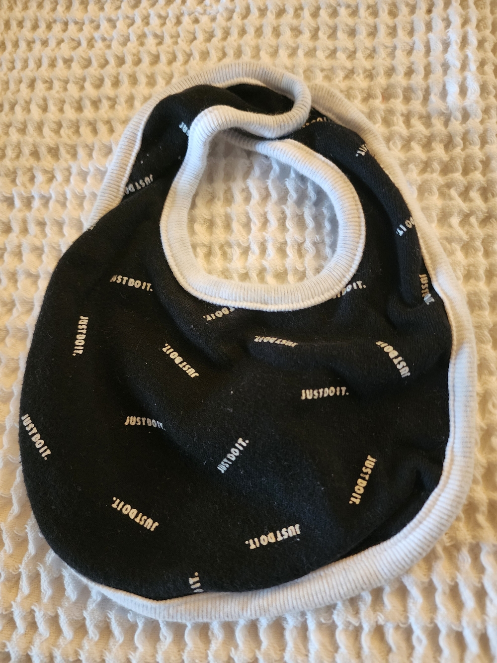 Nike Black Baby Bib with White Trim and 'Just Do It.' Print